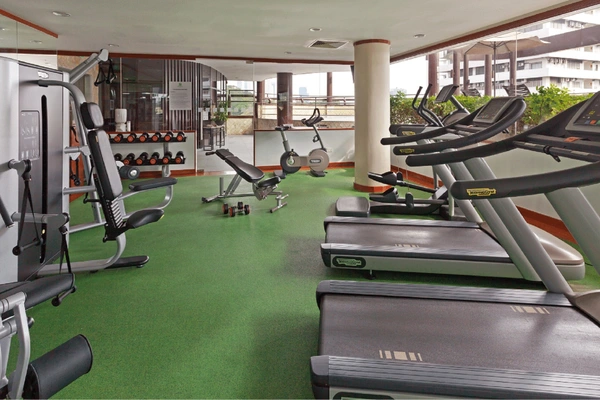 24-hour fitness center with elliptical machines and cross-trainers