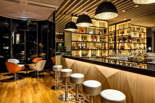 Unwind over bespoke cocktails and live music at Atrium Bar 317 in the evening